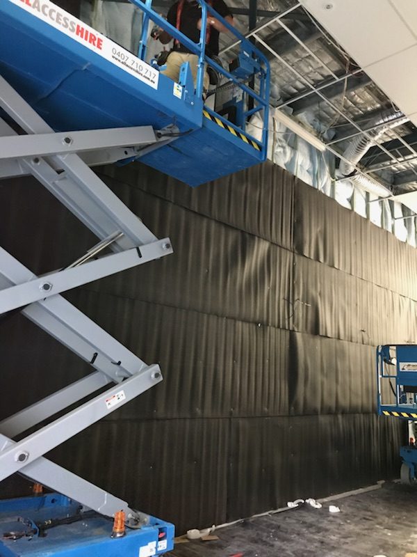 Sound-Stop 5 acoustic heavy polymer barrier installed on a wall in a warehouse
